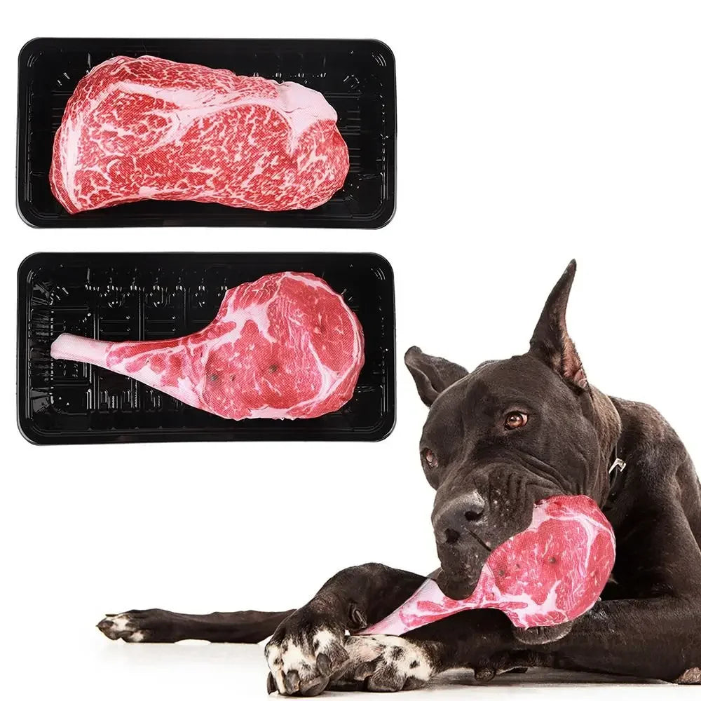 Black dog chewing a realistic squeaky tomahawk steak toy, with ribeye and tomahawk steak dog toys shown